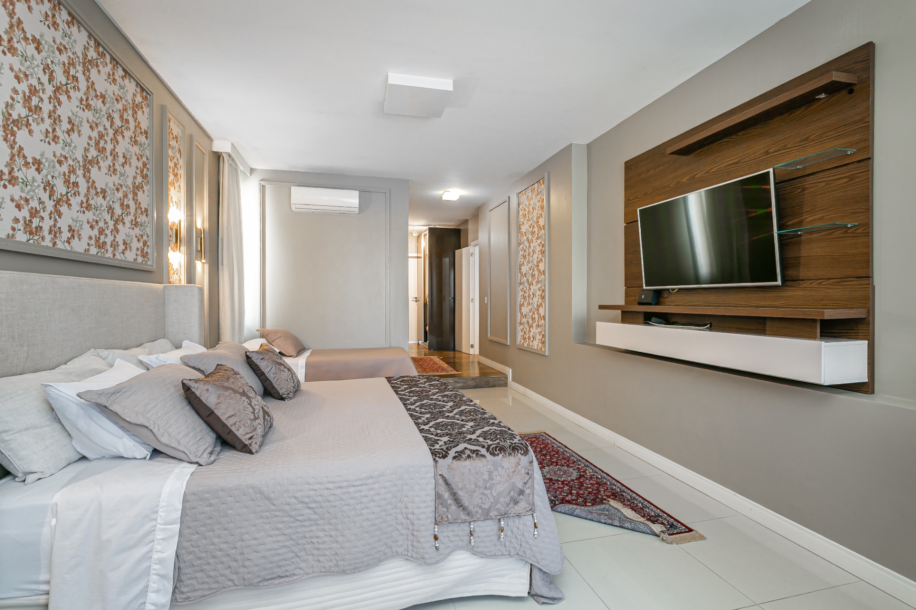 Quarto da Casa Noah com TV em painel de madeira